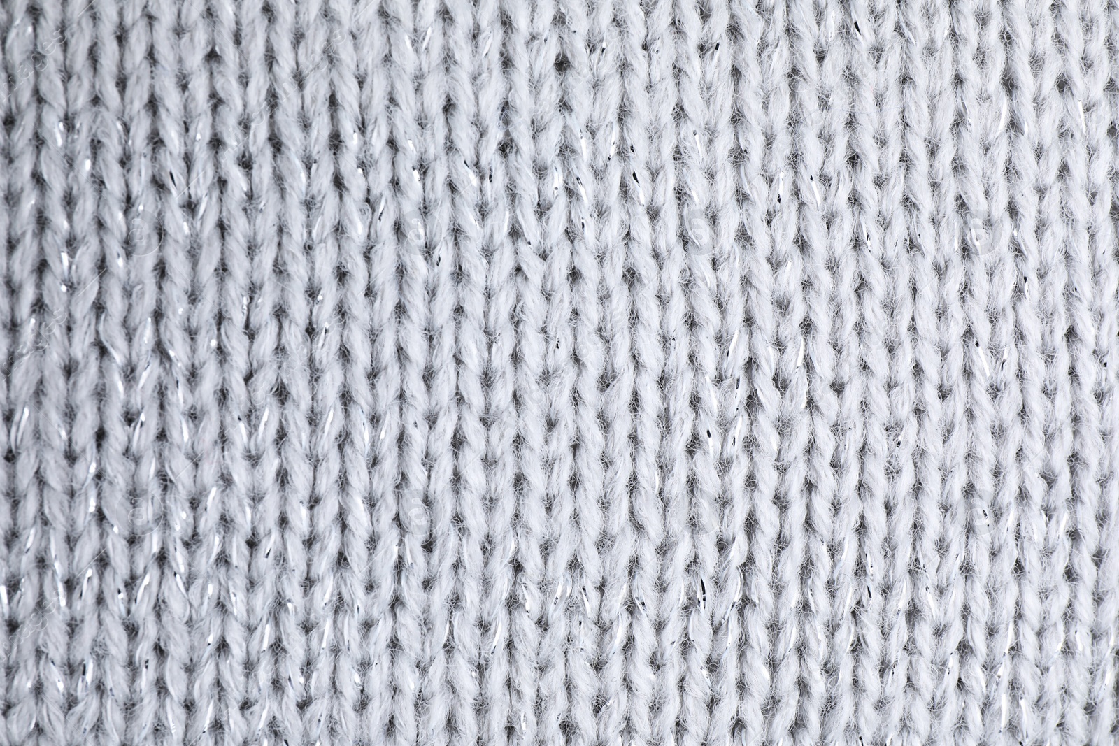 Photo of Warm knitted sweater as background, closeup view