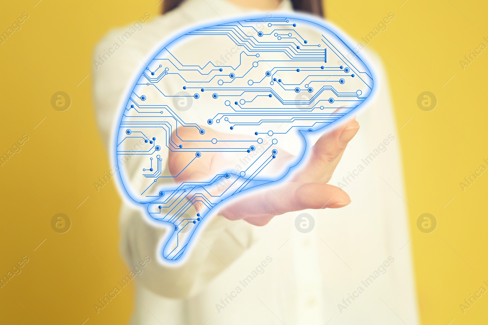 Image of Woman demonstrating digital image of brain on yellow background, closeup. Machine learning concept
