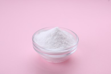 Photo of Bowl of sweet powdered fructose on pink background