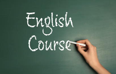Image of Woman writing words ENGLISH COURSE on chalkboard, closeup