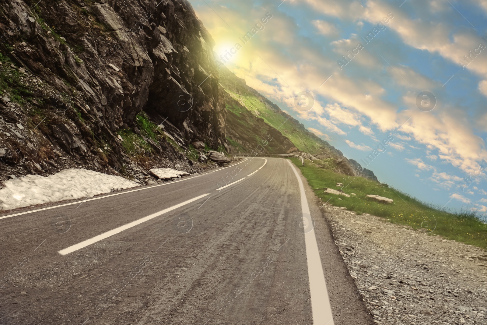 Image of Road trip. Beautiful view of asphalt highway along crag on sunny day 