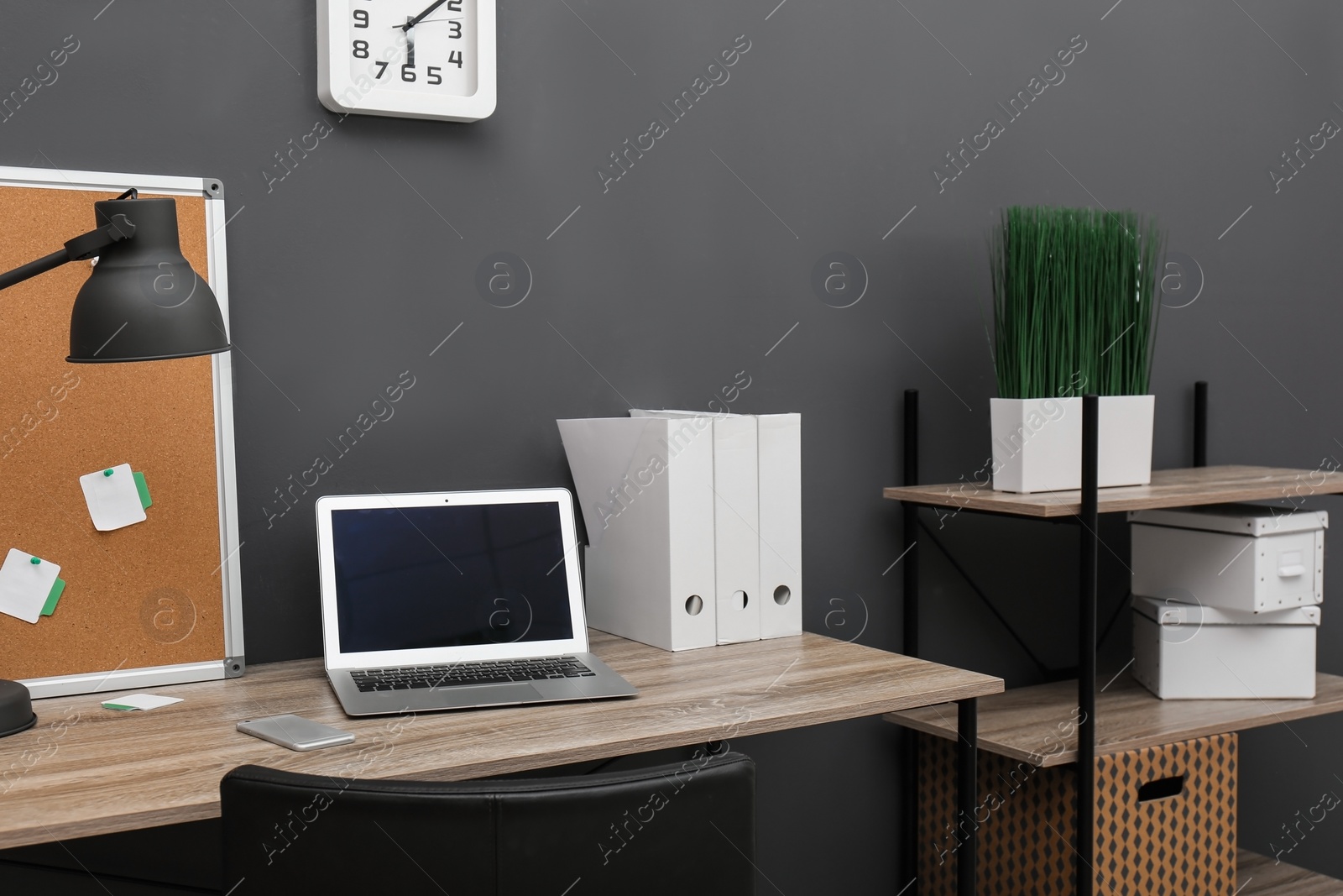 Photo of Stylish workplace with modern laptop in home office