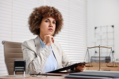 Notary with clipboard and pen at workplace in office