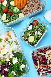 Photo of Set of glass containers with fresh food on light blue background, flat lay