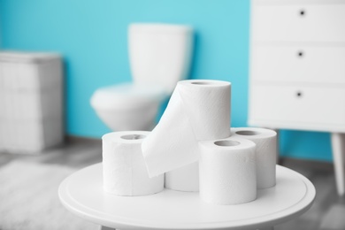 Photo of Toilet paper rolls on table in bathroom