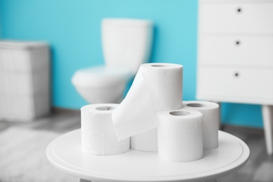 Toilet paper rolls on table in bathroom