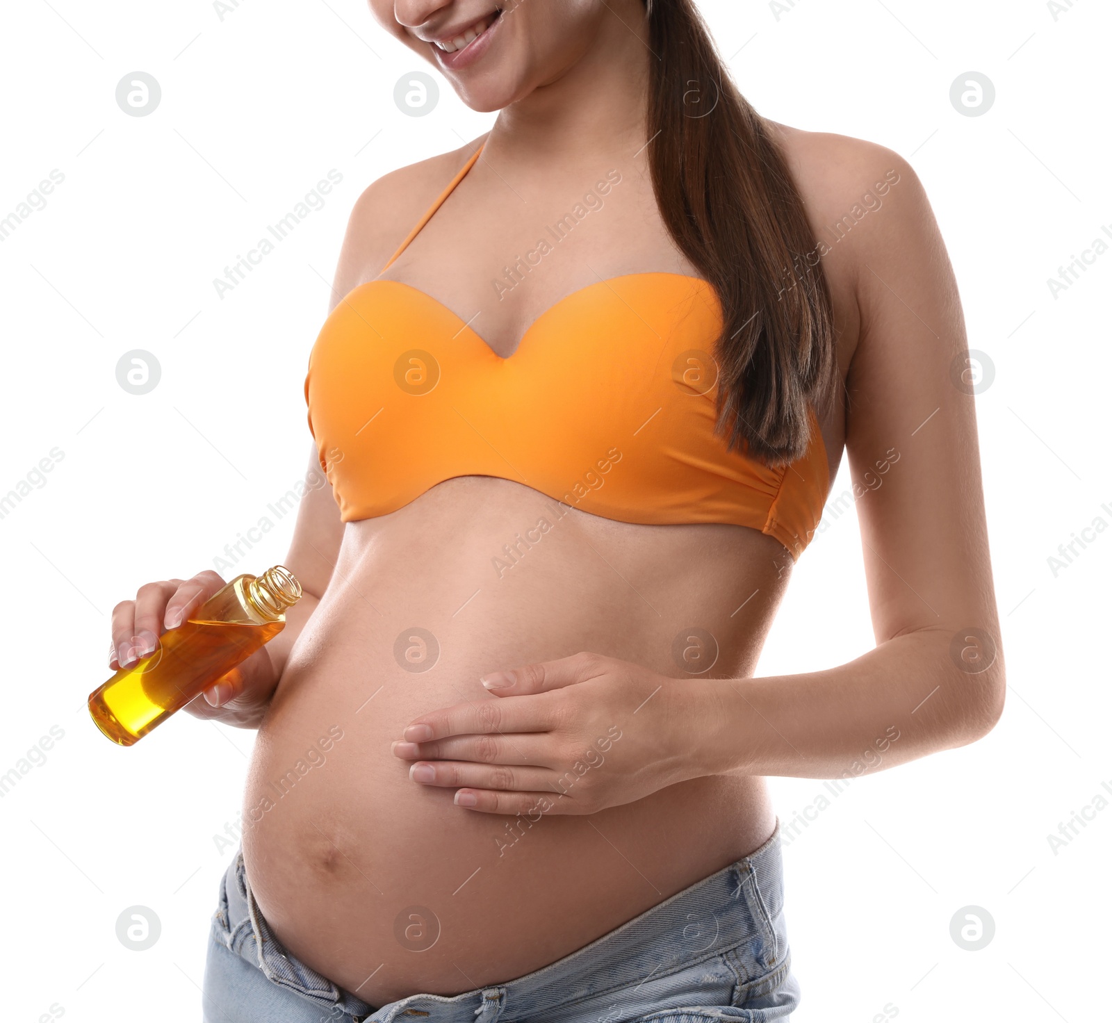 Photo of Young pregnant woman with sun protection oil on white background, closeup