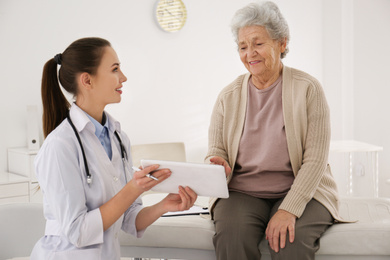 Photo of Senior woman visiting doctor in modern office