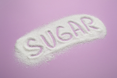 Photo of Composition with word SUGAR on lilac background