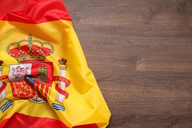 Photo of Flag of Spain on wooden background, top view. Space for text