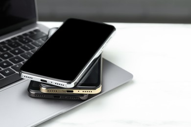 Photo of Stack of electronic devices on white table. Space for text