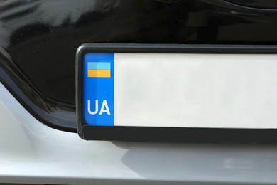 Car with vehicle registration plate, closeup view