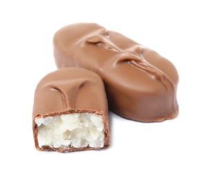 Delicious milk chocolate candy bars with coconut filling on white background