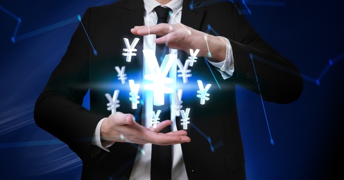 Image of Money exchange concept. Businessman with Japanese yen currency symbols on blue background, closeup