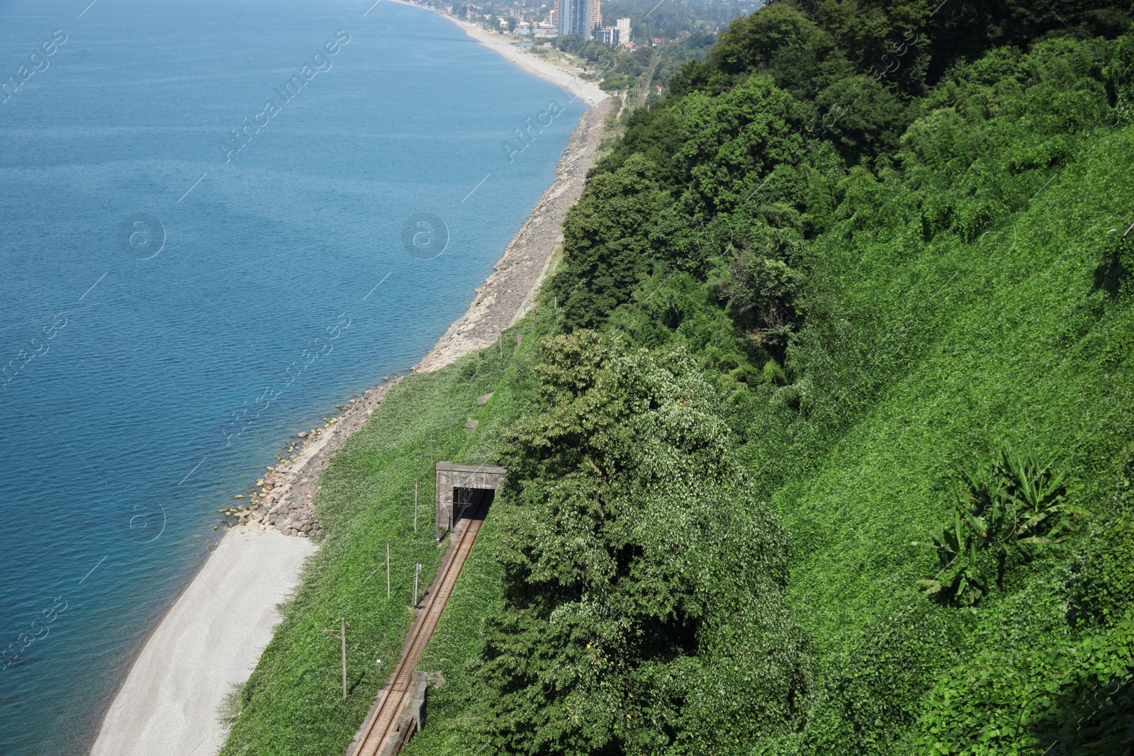 Photo of Picturesque view of green hills and sea with clear water