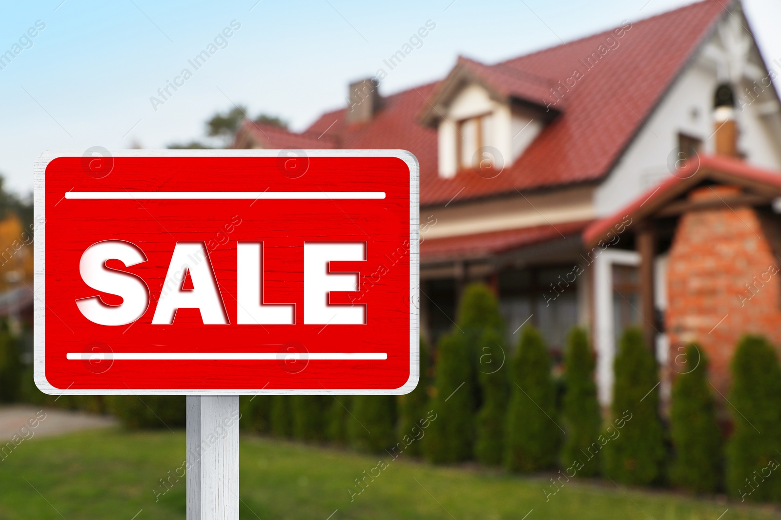 Image of Sale sign near beautiful house outdoors. Red signboard with word