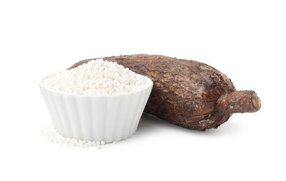 Photo of Tapioca pearls in bowl and cassava root isolated on white