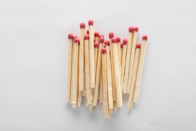 Pile of wooden matches on white background, top view