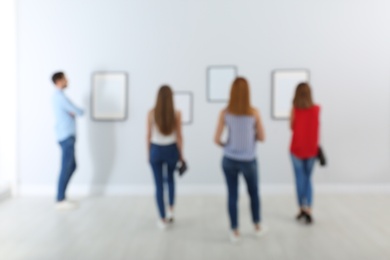 People in modern art gallery, blurred view