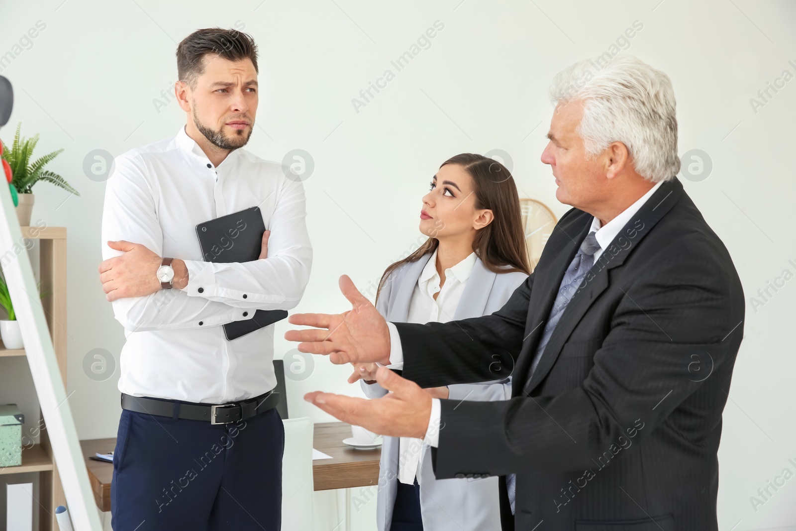 Photo of Office employees having argument at workplace