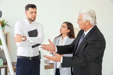 Photo of Office employees having argument at workplace
