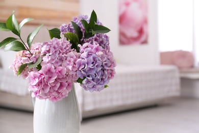 Photo of Closeup view of hydrangea flowers in bedroom, space for text. Interior design