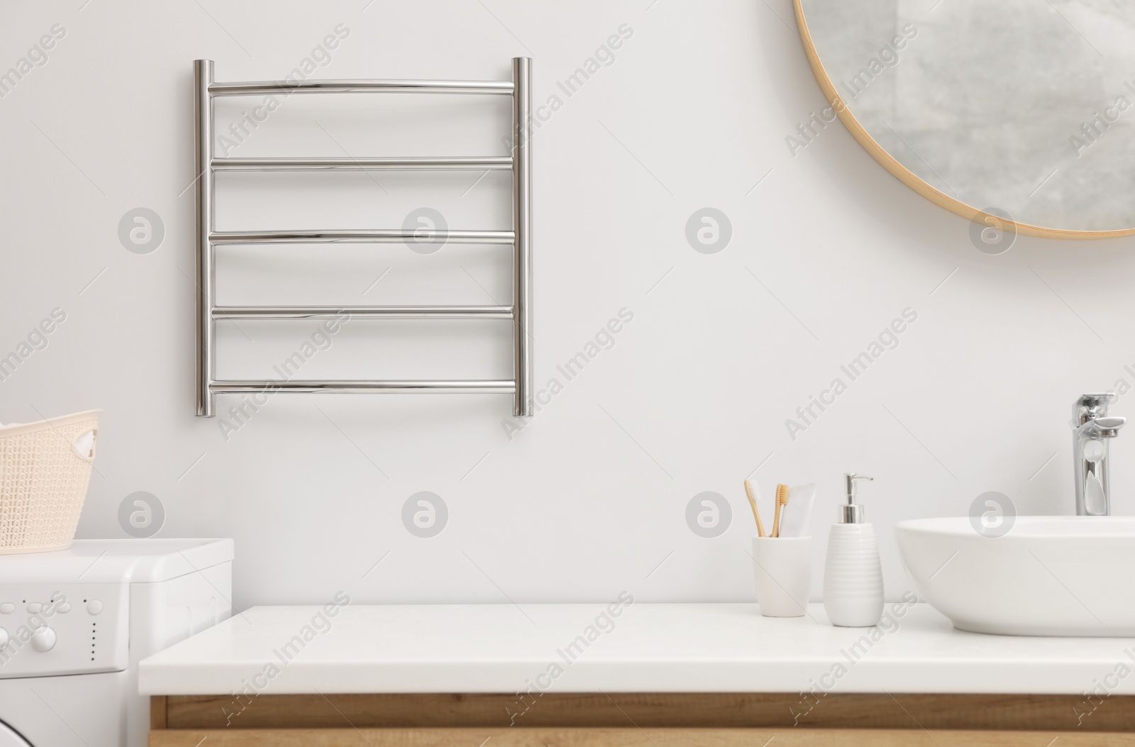 Photo of Stylish bathroom interior with heated towel rail and vanity