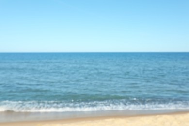 Photo of Blurred view of sandy beach near sea