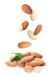 Image of Many fresh almonds falling on white background