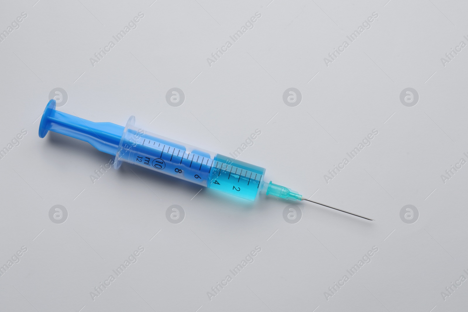 Photo of Disposable syringe with needle and medicine isolated on white, top view