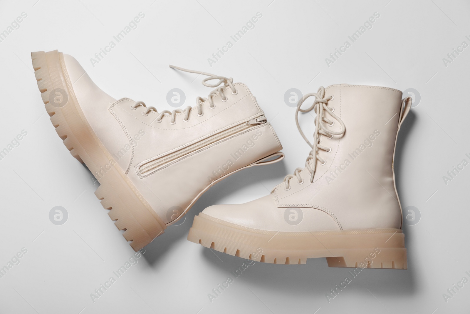 Photo of Pair of stylish leather shoes on beige background, flat lay