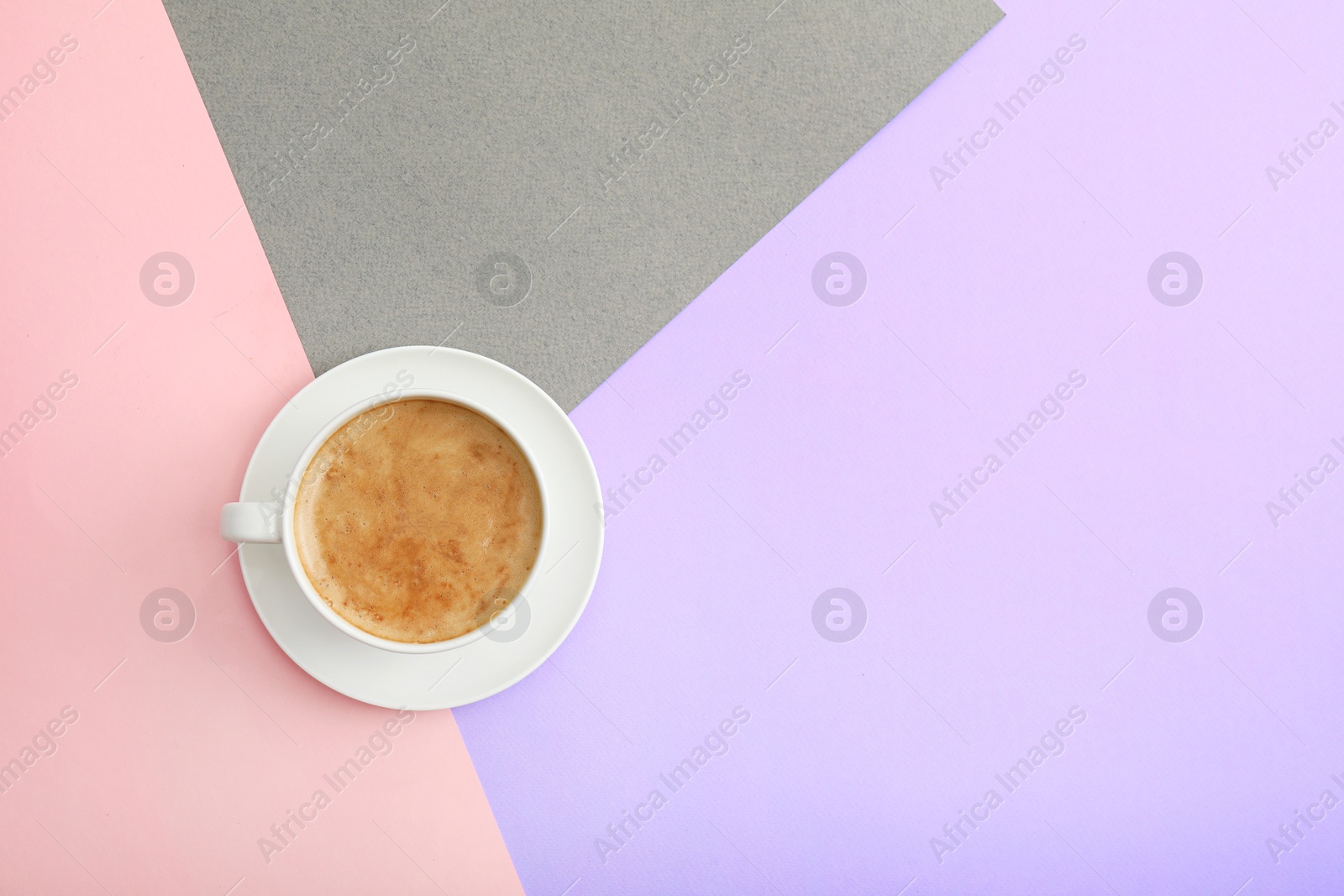 Photo of Cup of coffee on color background, top view. Space for text