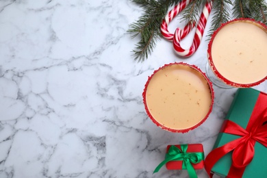 Delicious Christmas liqueur on white marble table, flat lay. Space for text