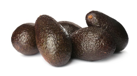 Whole fresh ripe avocadoes on white background