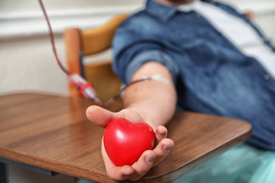 Photo of Man donating blood in hospital, closeup view