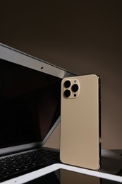 Photo of Many different modern gadgets on brown background, closeup