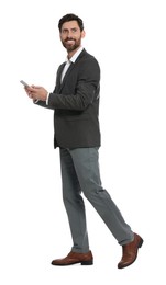 Photo of Handsome man with smartphone walking on white background