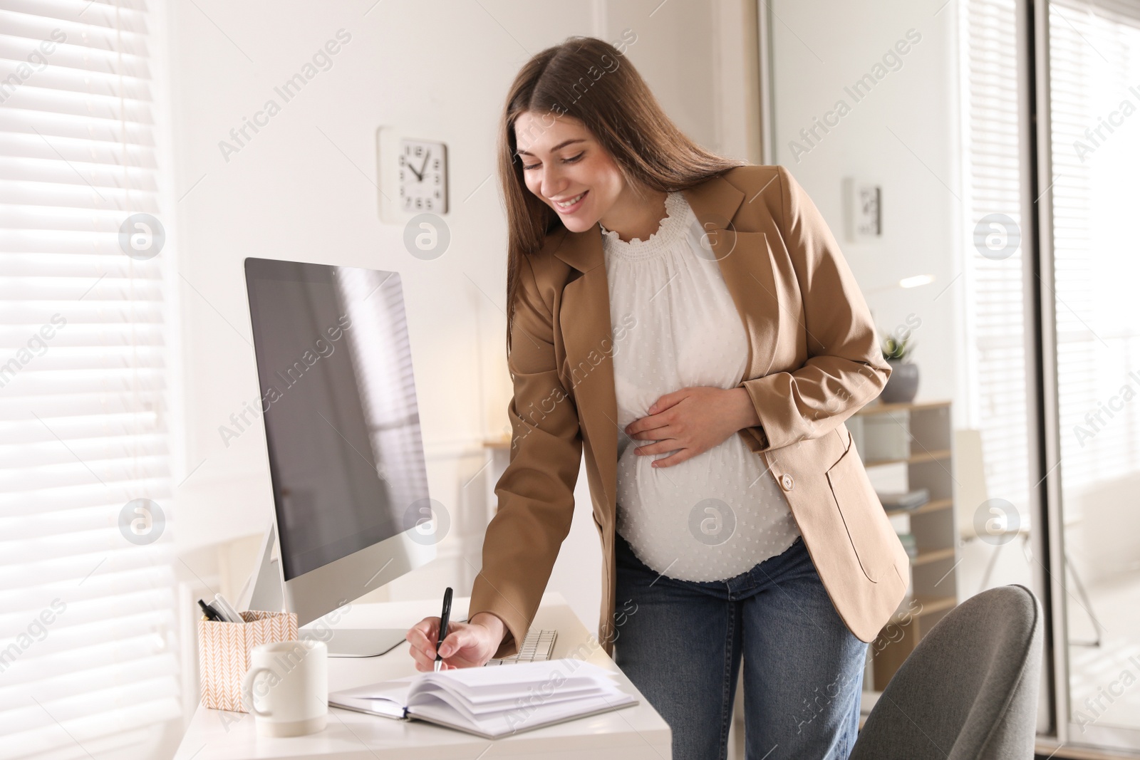 Photo of Pregnant woman working at home. Maternity leave