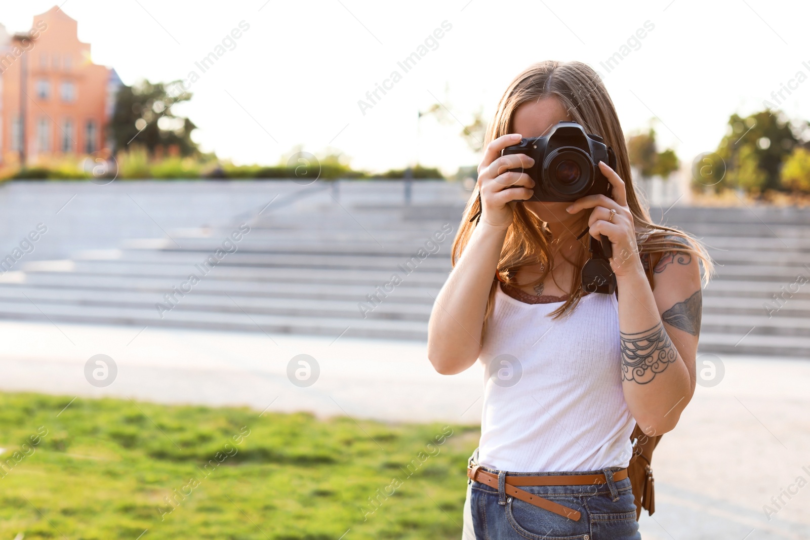 Photo of Young woman with camera on city street