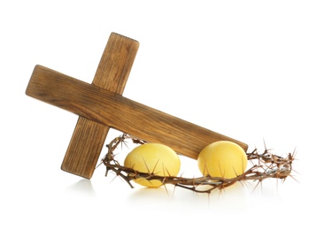 Photo of Wooden cross, crown of thorns and Easter eggs on white background