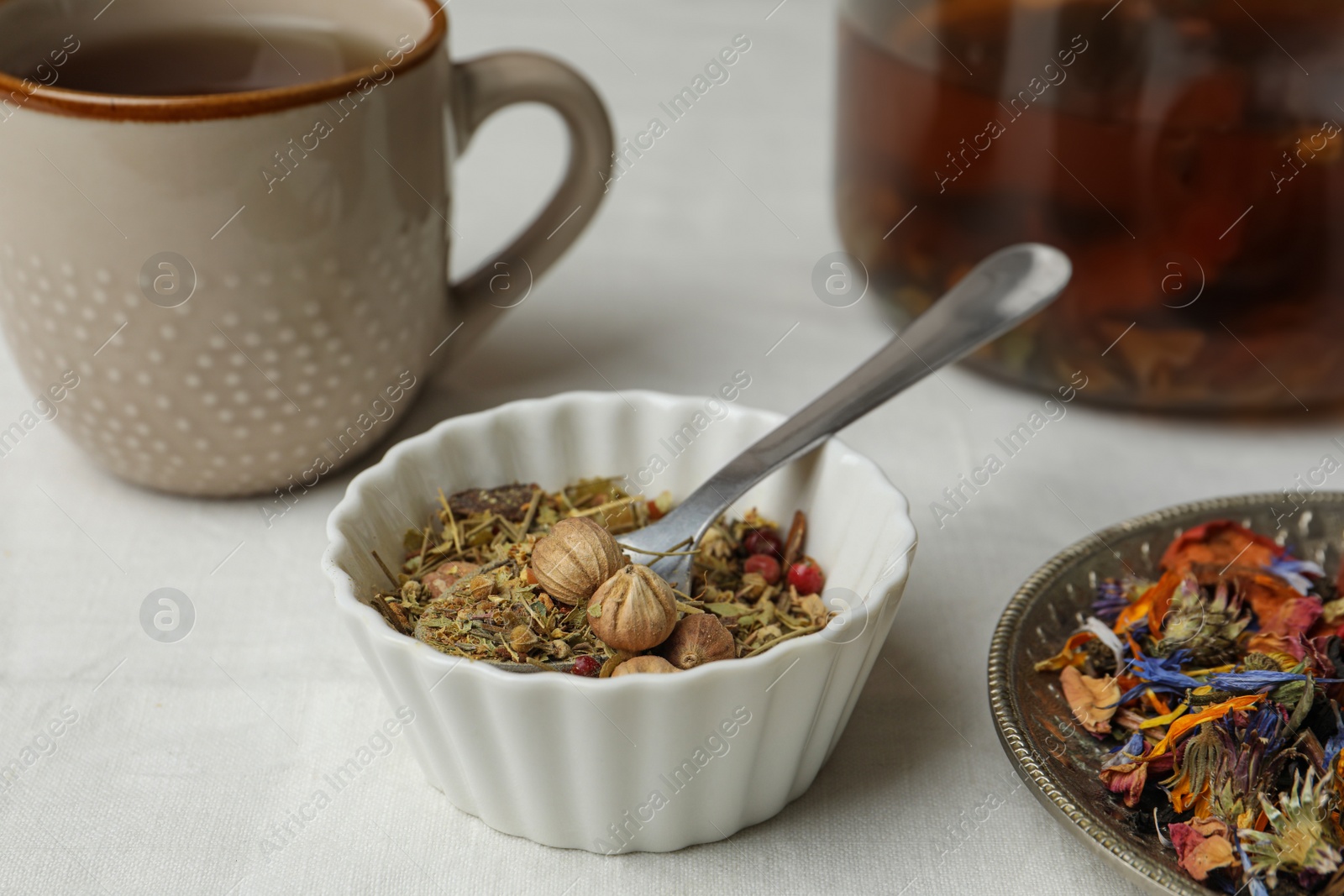 Photo of Aromatic dried herbs and berries for tea on white table