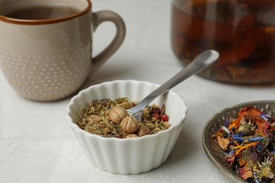 Photo of Aromatic dried herbs and berries for tea on white table