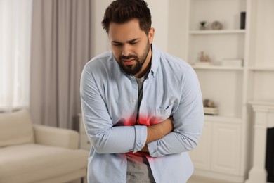 Image of Man suffering from abdominal pain at home