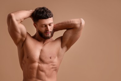 Photo of Handsome muscular man on beige background, space for text. Sexy body