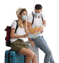 Photo of Couple in face masks with map on white background. Summer travel