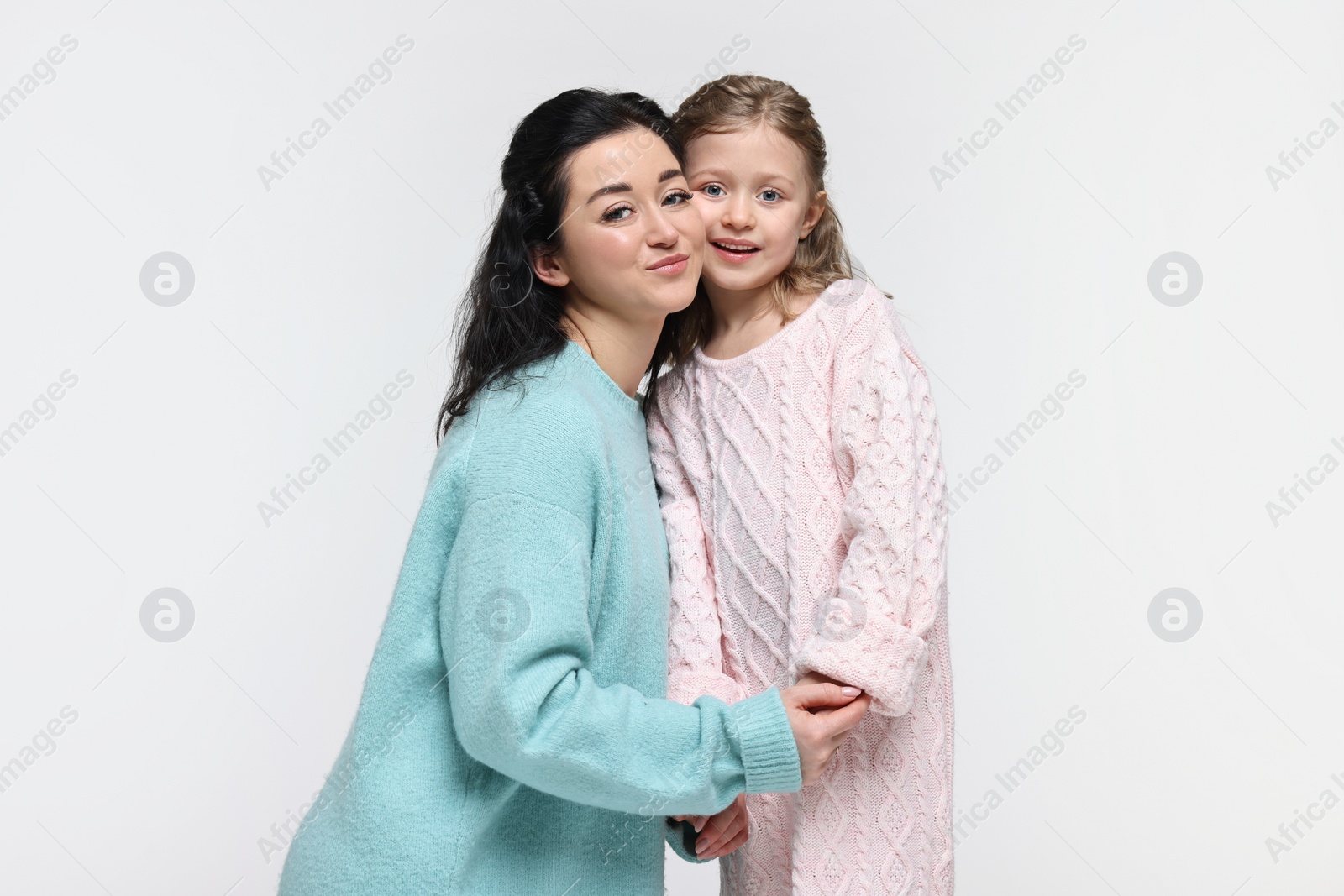 Photo of Beautiful mother with little daughter on white background