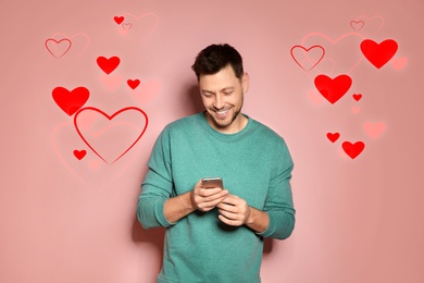Man visiting dating site via smartphone on color background