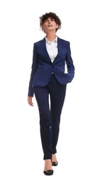 Photo of Beautiful businesswoman in suit walking on white background, low angle view