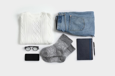 Flat lay composition with female winter clothes on white background