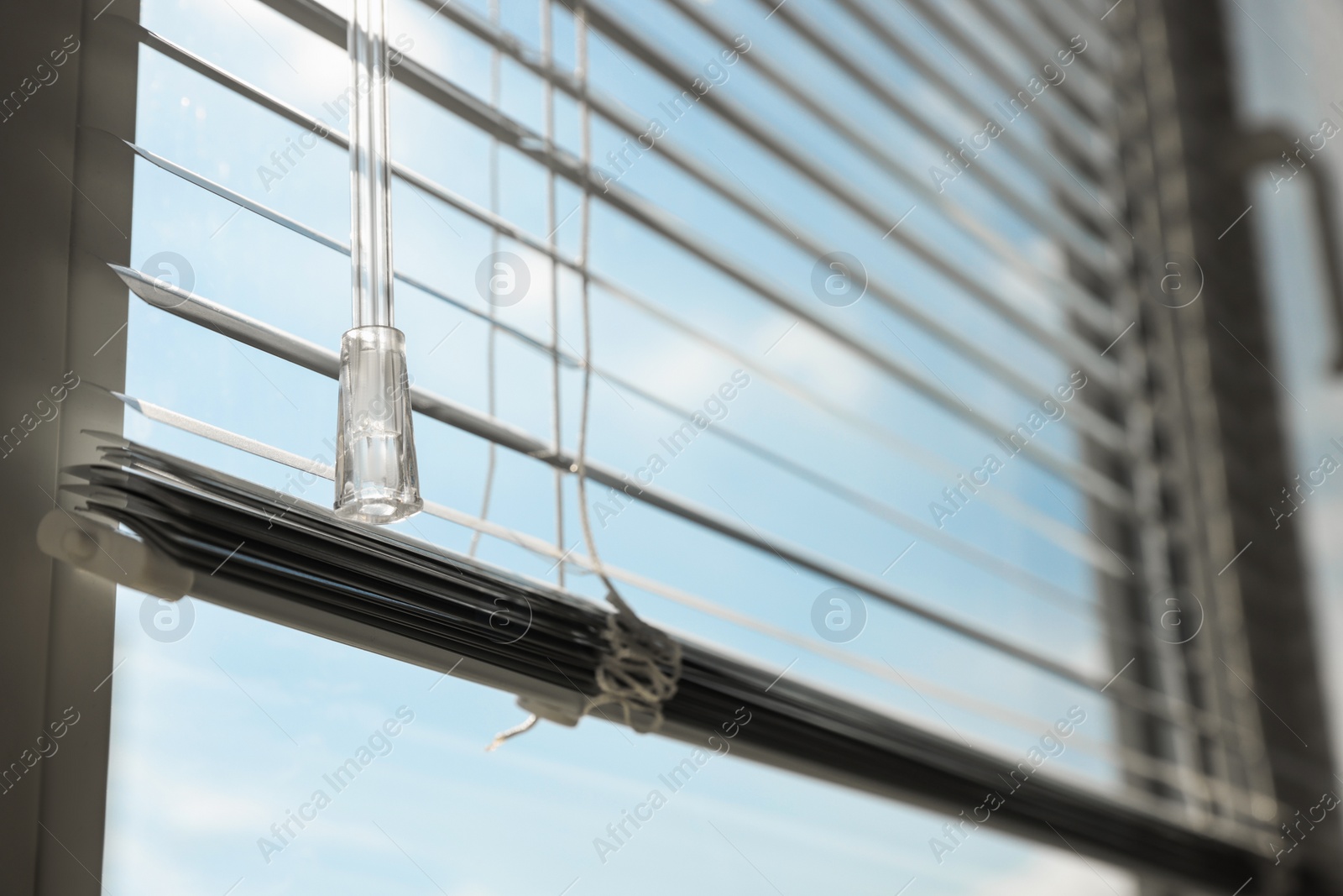 Photo of Stylish window with horizontal blinds indoors, closeup. Space for text